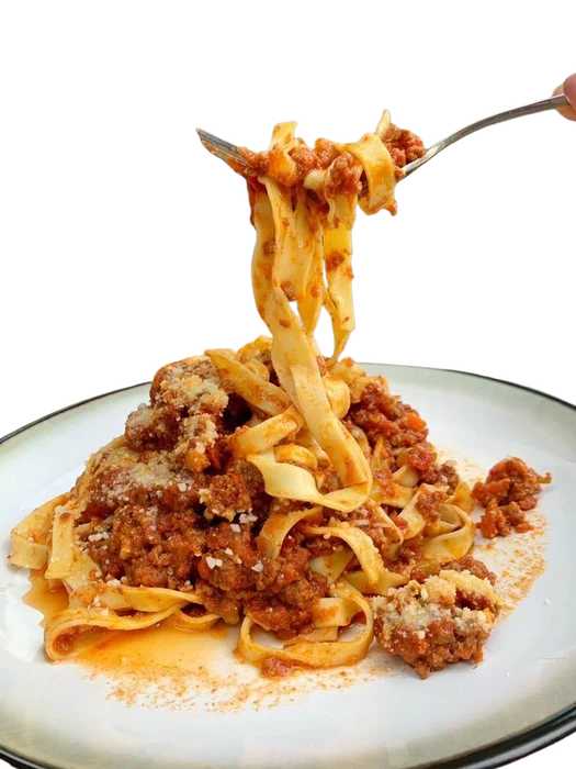 Pasta lifted from a plate at SLYCE Pizza Cafe